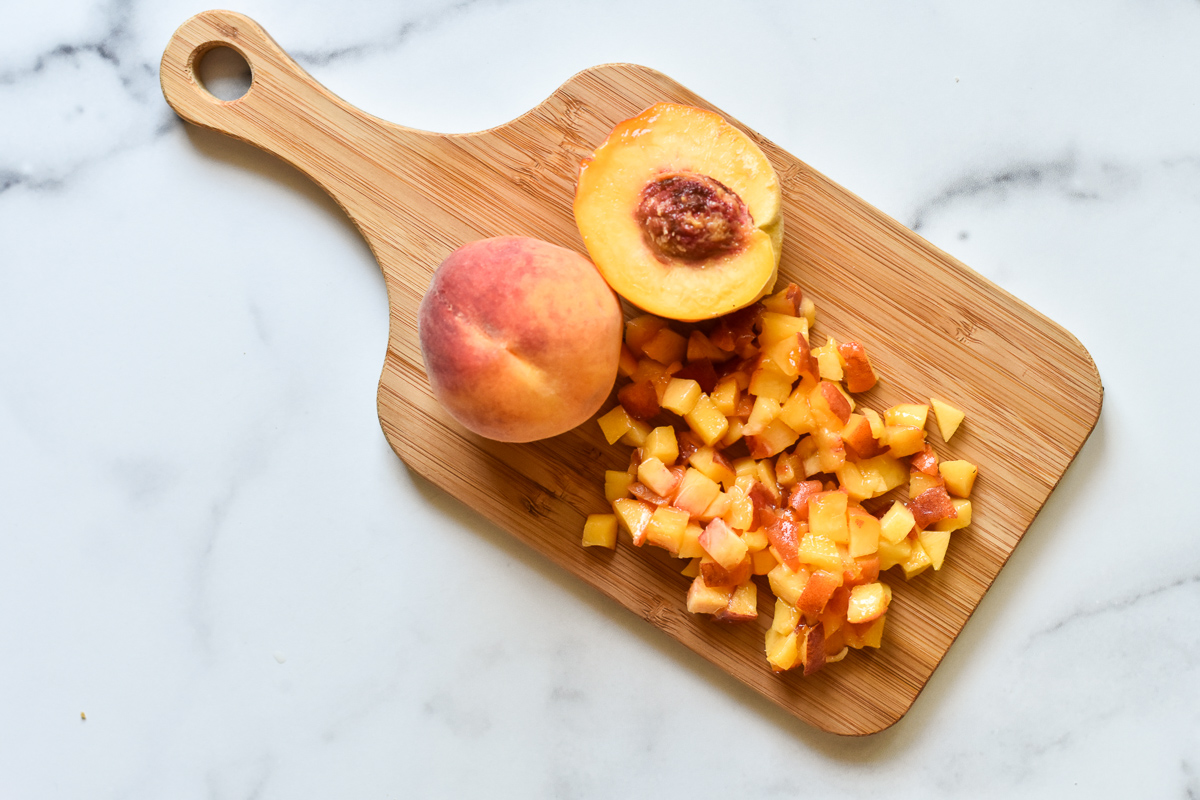 peach on a wood cutting board