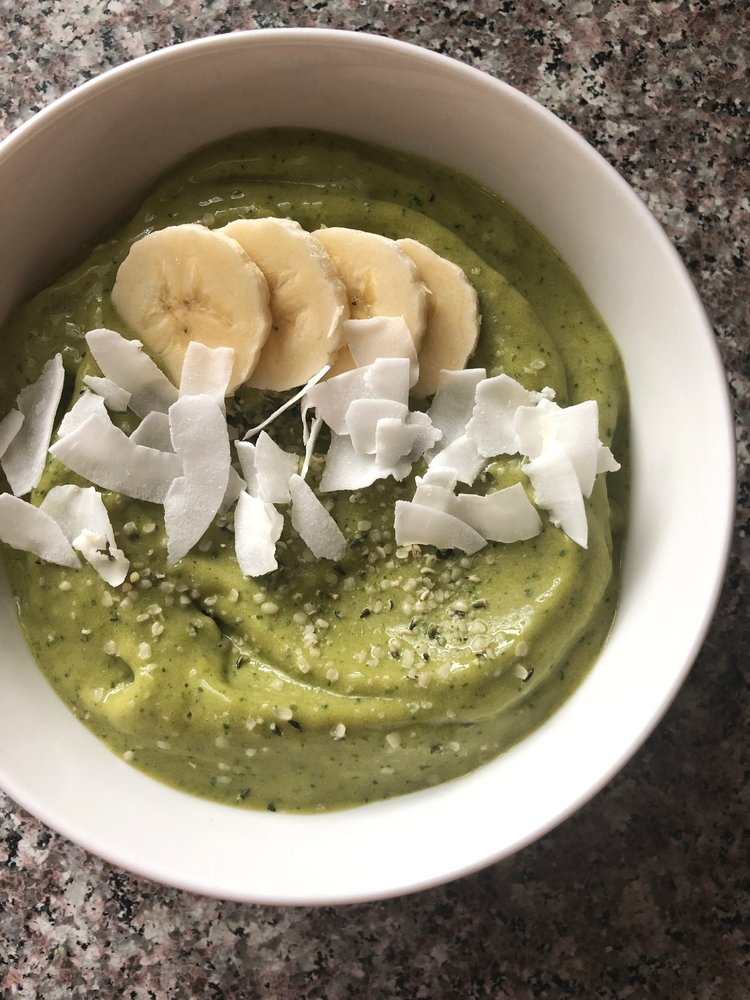 matcha green tea ginger smoothie bowl with bananas and coconut flakes and hemp seeds