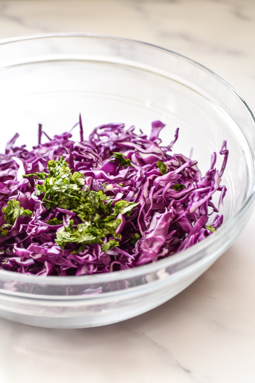 shredded purple cabbage and cilantro in a bowl