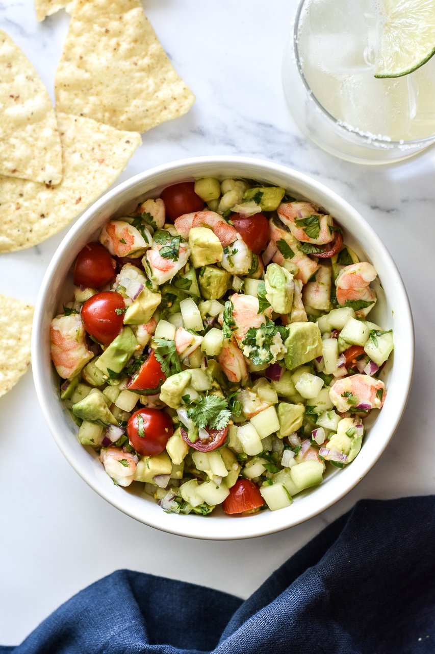 shrimp ceviche in a bowl with chips and a margarita