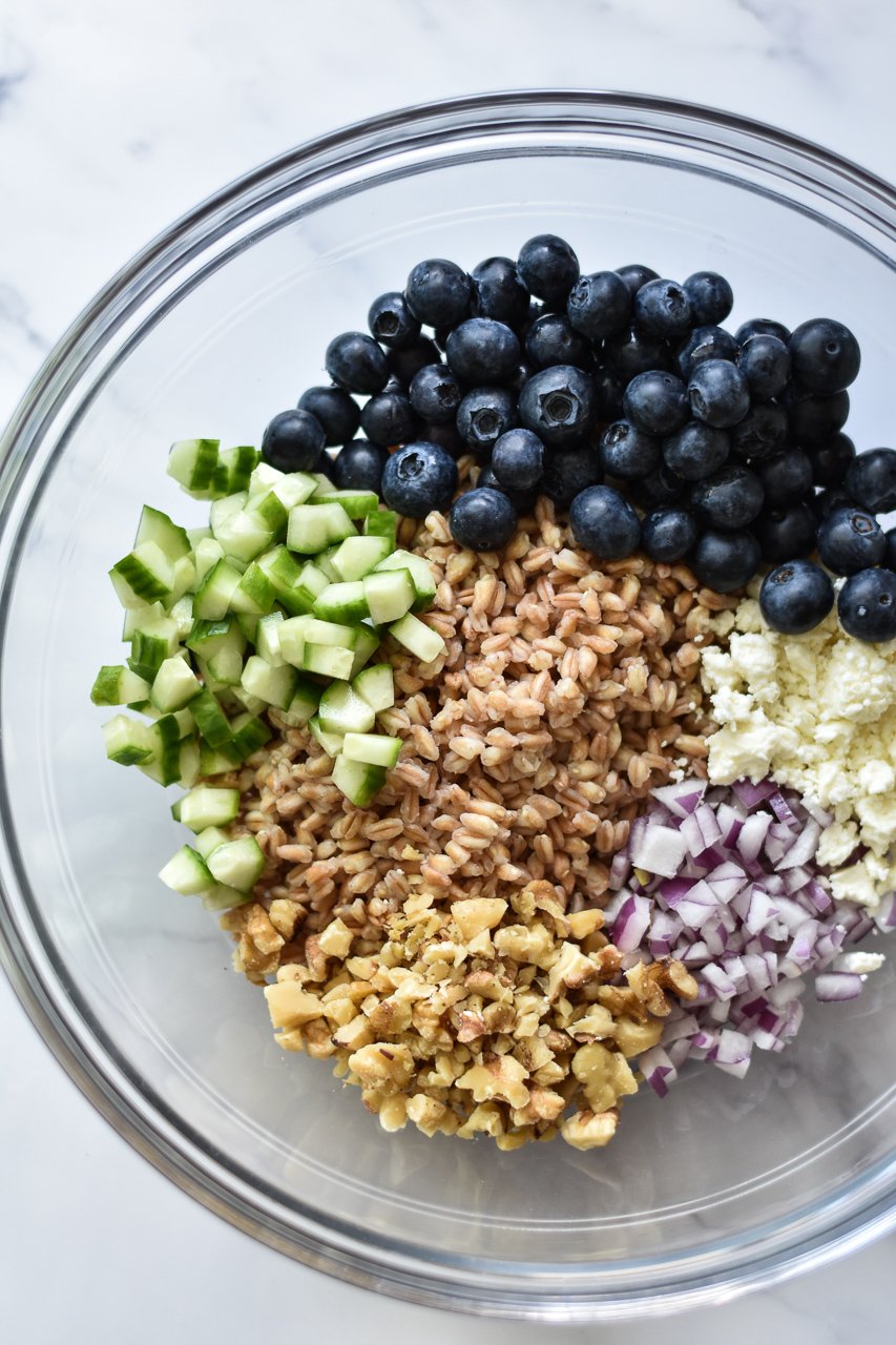 ingredients for summer farro salad in a large mixing bowl