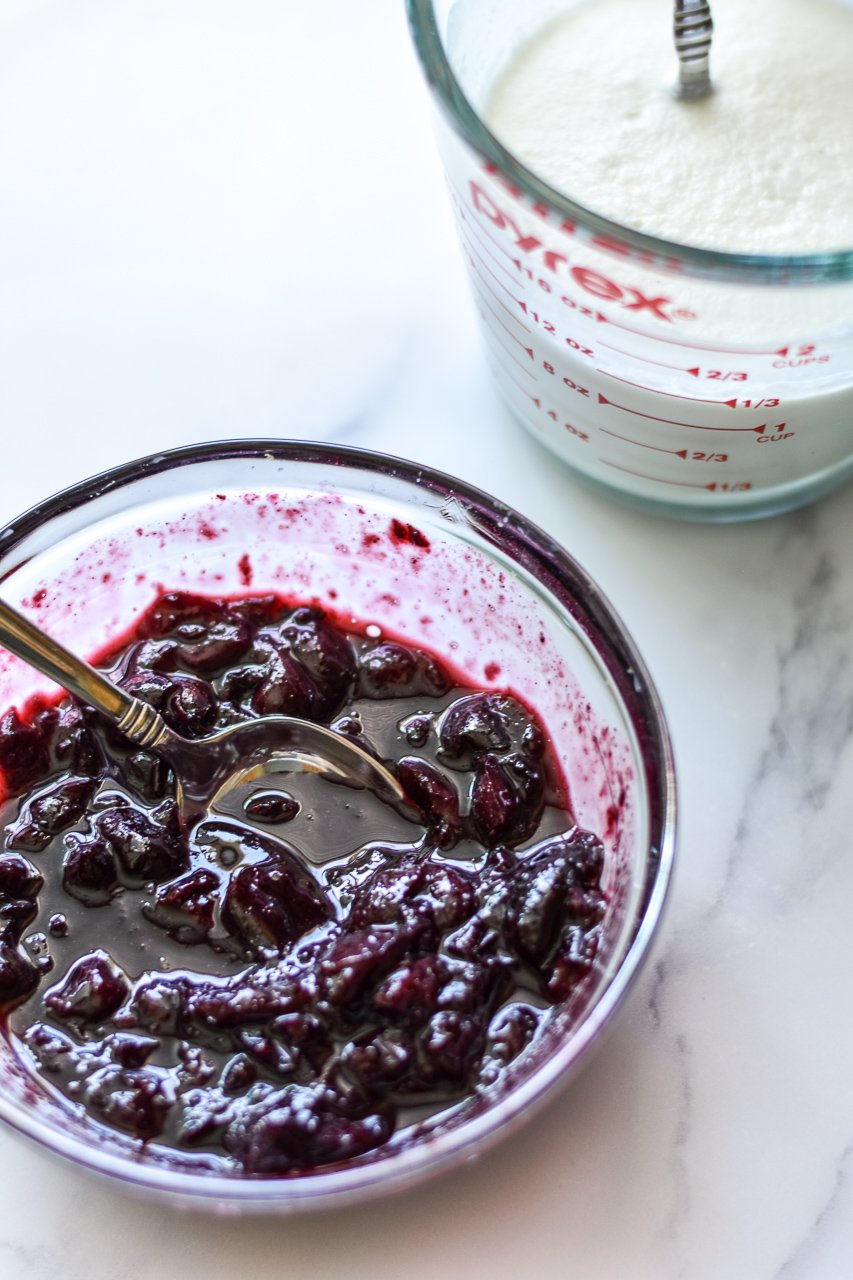 cherry jam and measuring cup of yogurt