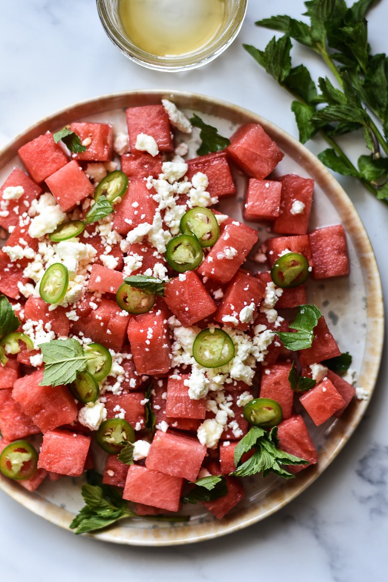 watermelon salad with feta mint and hot honey on a plate