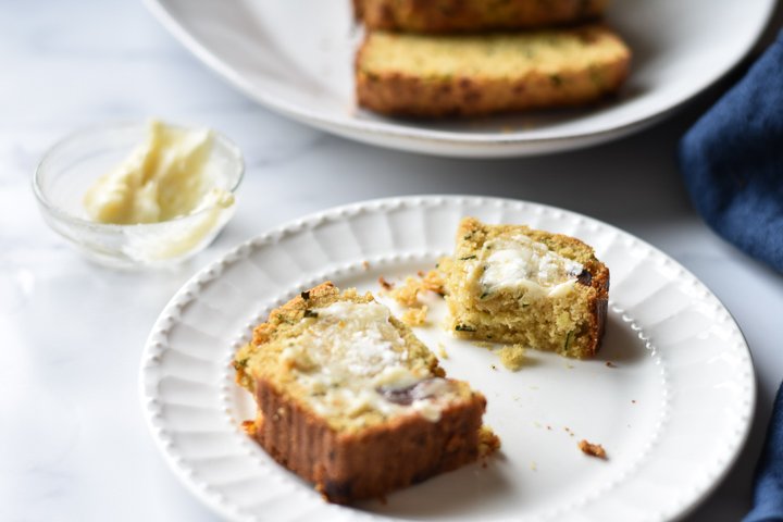 slice of zucchini bread with honey butter on a plate