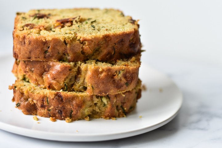 zucchini bread slices stacked on a plate