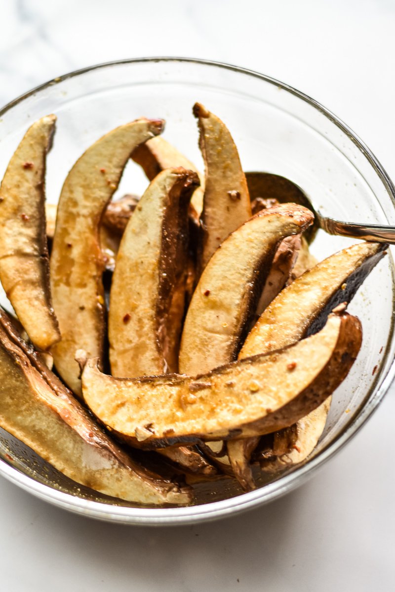 sliced and marinated portobello mushrooms in a bowl