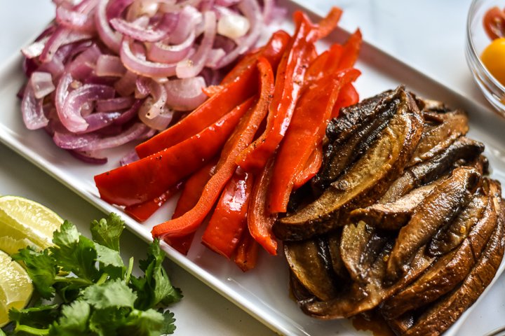 platter of cooked portobello mushrooms and fajita veggies