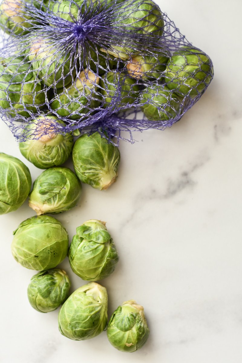 bag of brussels sprouts spilling out on the counter