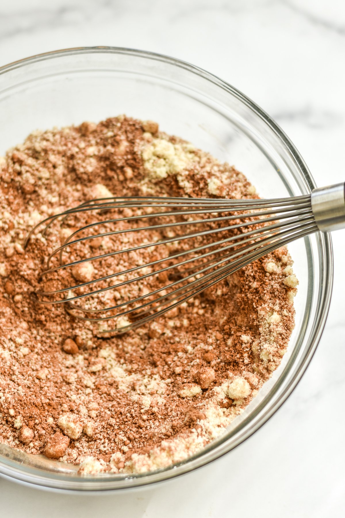 almond flour and dry ingredients whisked in a glass bowl