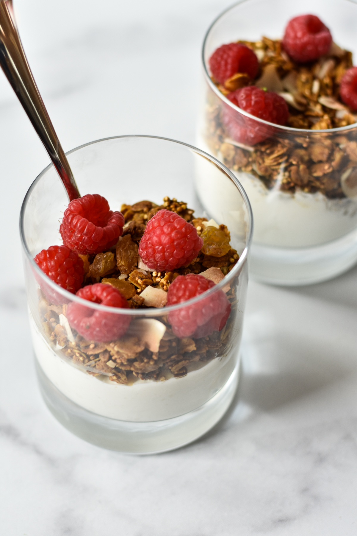 yogurt, granola and raspberries layered in glasses