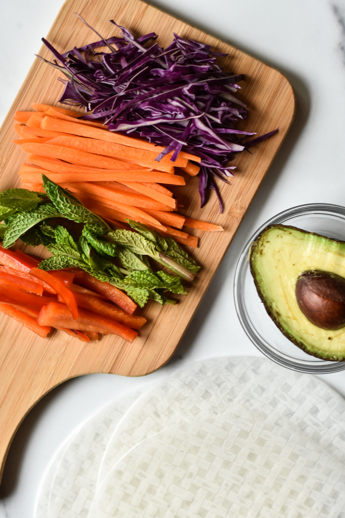 ingredients for summer rolls on a wooden cutting board