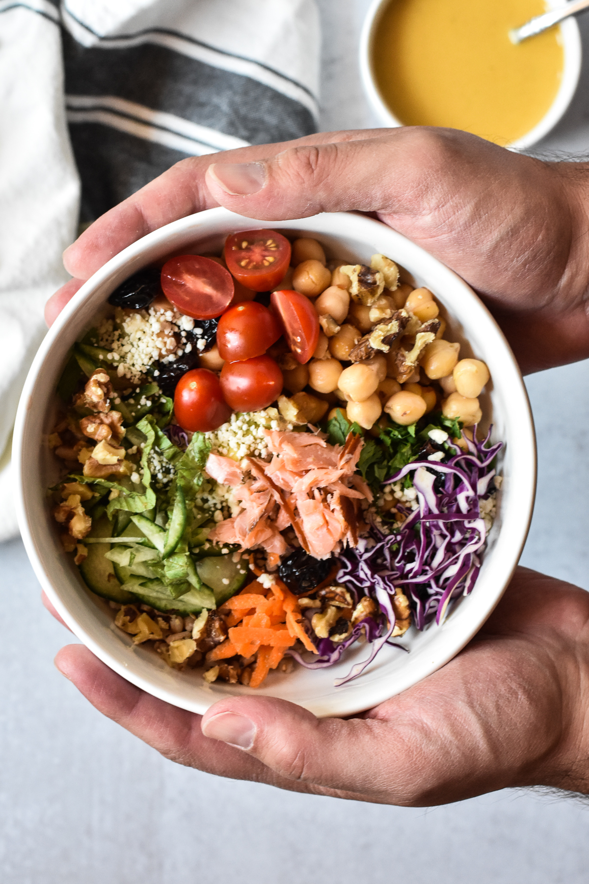 nourish bowl with tahini sauce in the background