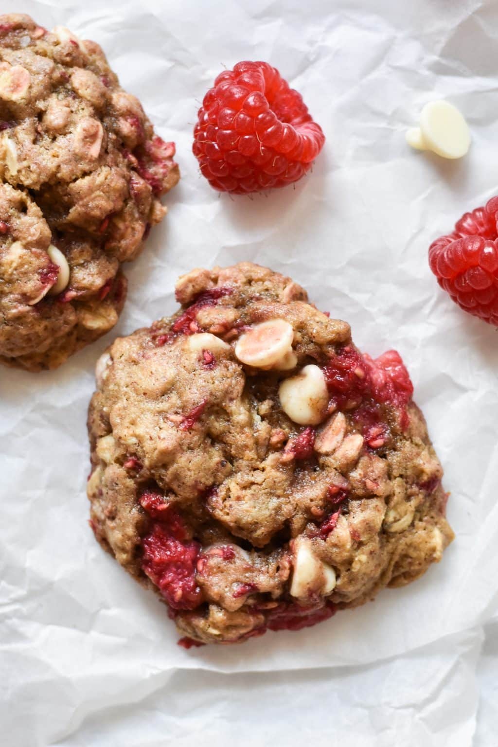 cookie with raspberries on parchment paper