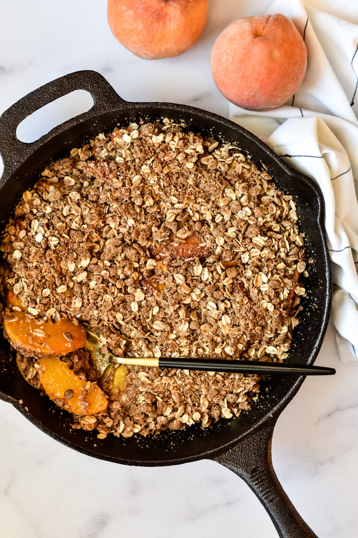 gluten-free peach crisp in a cast iron skillet