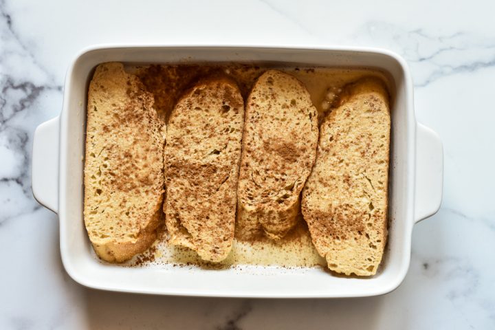 baking dish with sourdough bread soaking in egg