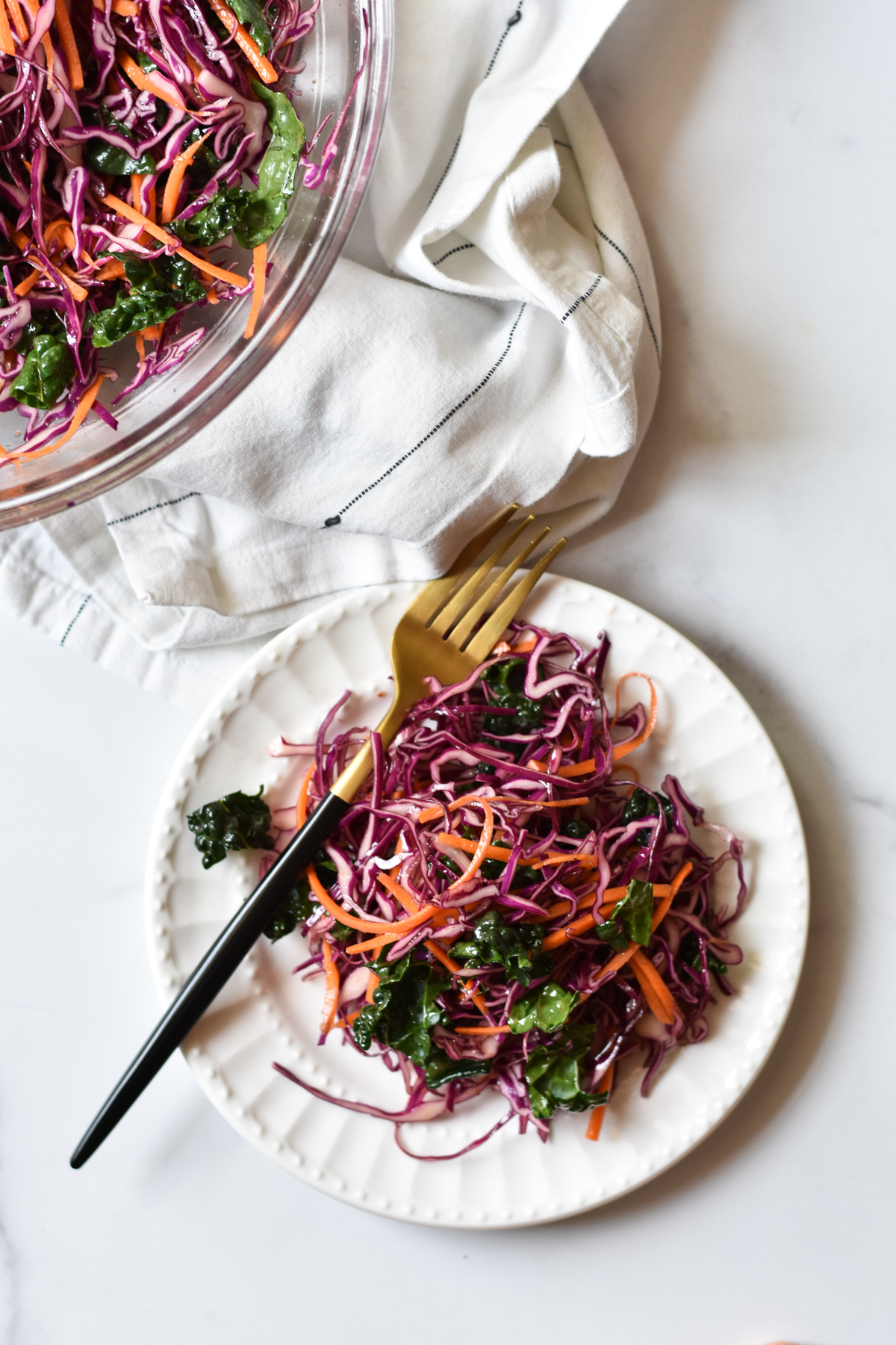 purple cabbage slaw on a plate with fork