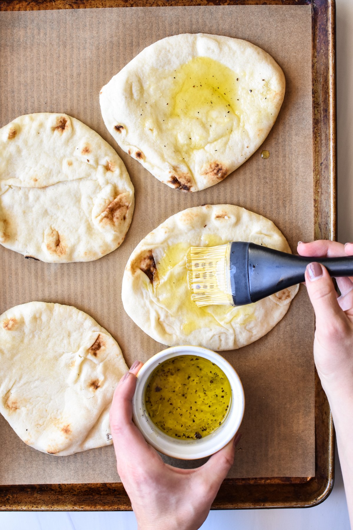 brushing oil on flatbread