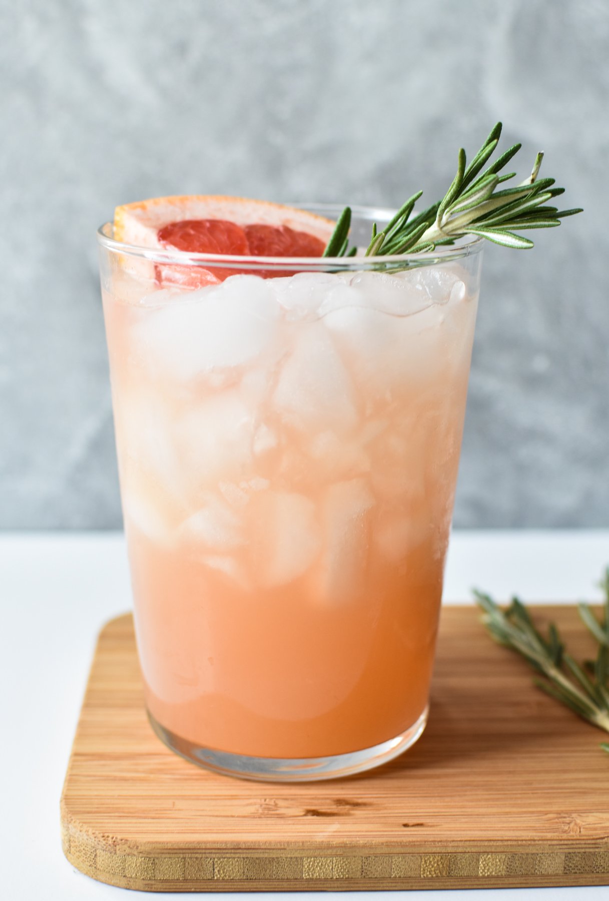 grapefruit mocktail in a tall glass with rosemary 