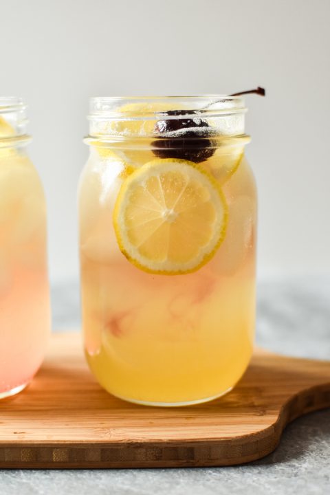 tom collins mocktail with cherry and lemon