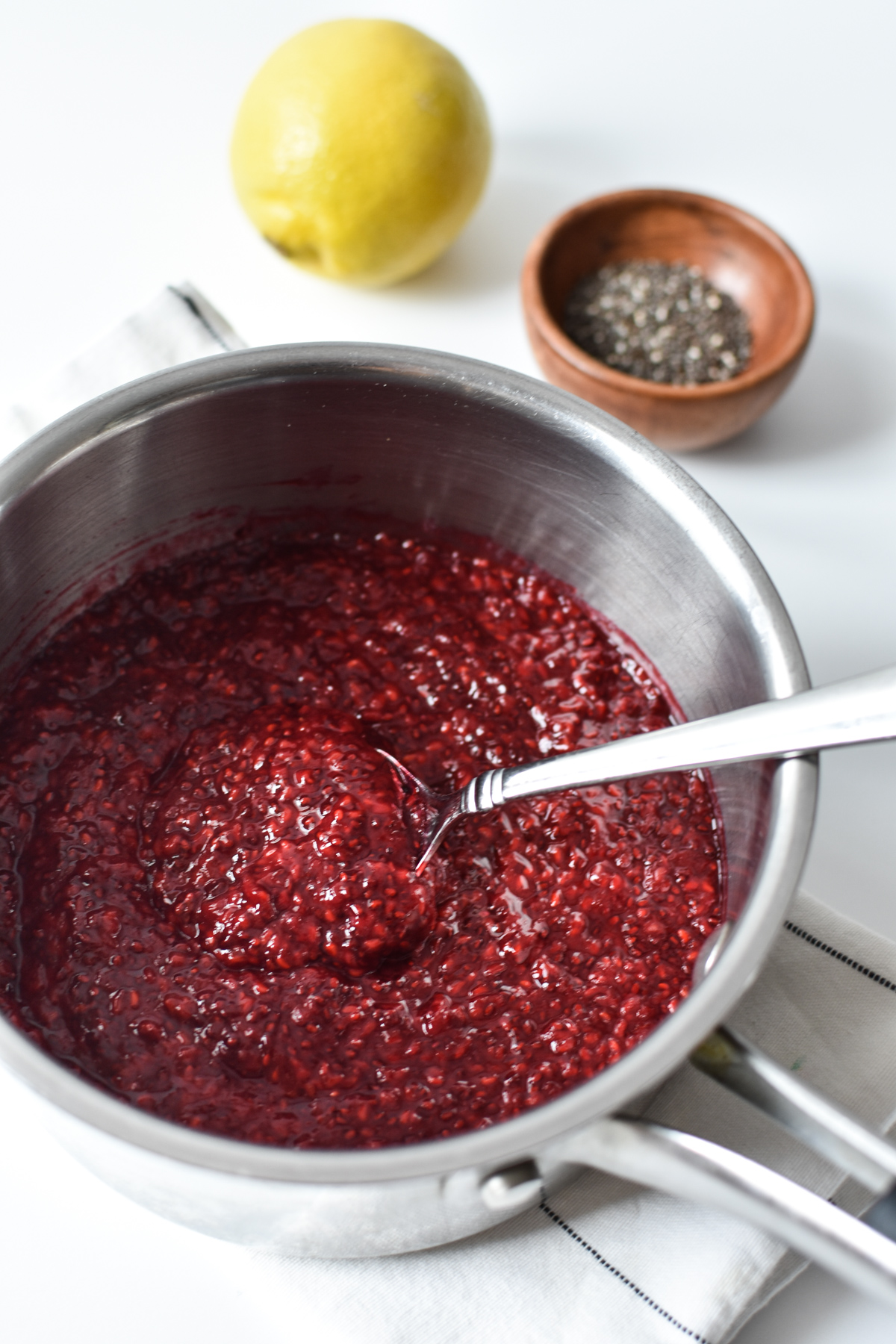 chia jam in a sauce pan with lemon and chia seeds 