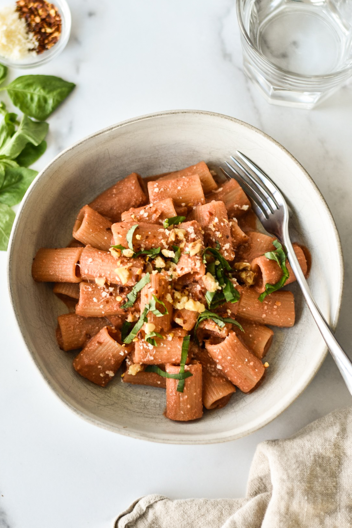 spicy rigatoni with basil, red pepper flakes and walnuts on top