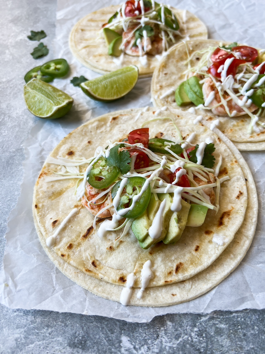 shrimp baja tacos up close with lime in the background