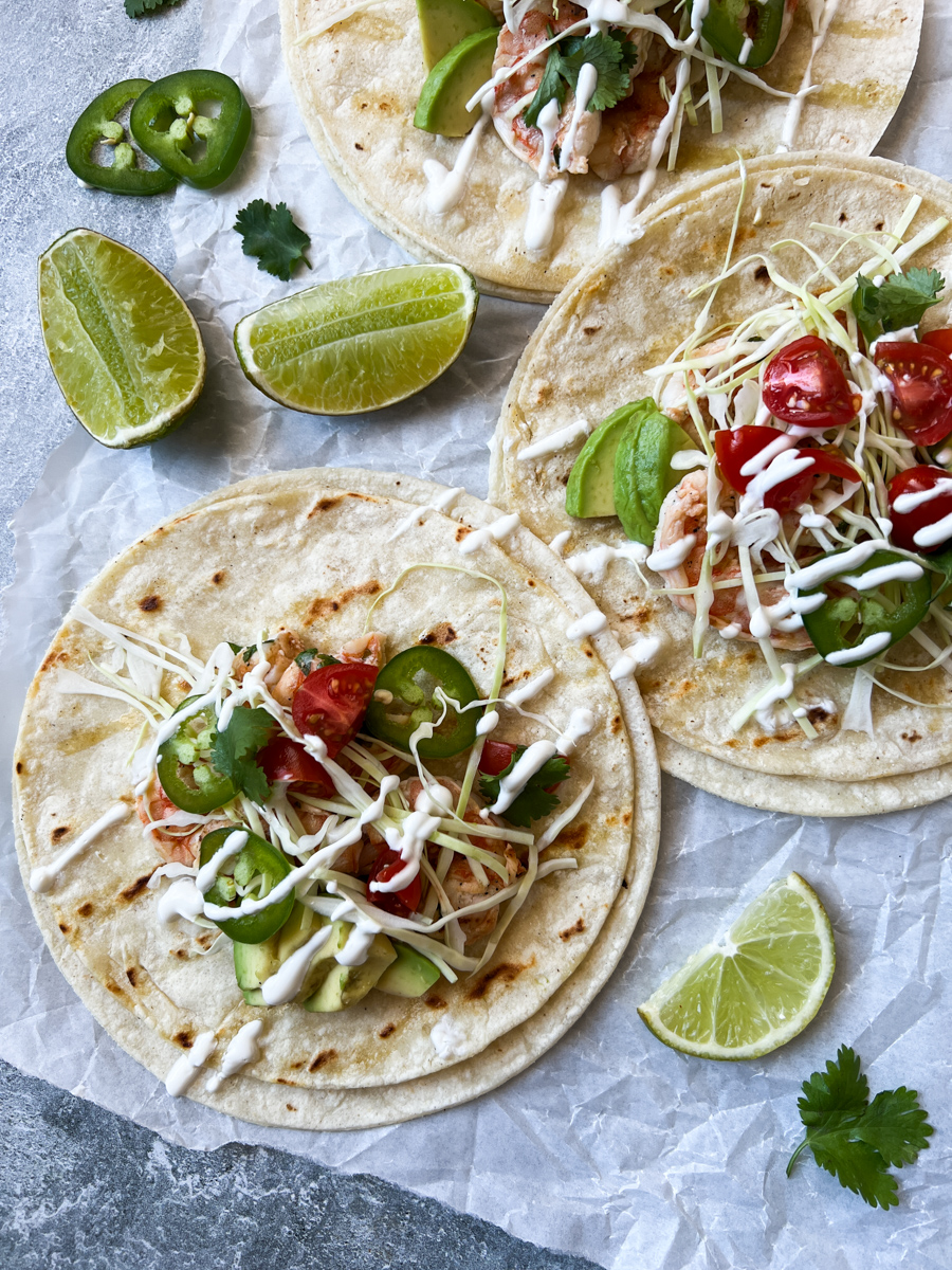 shrimp baja tacos with limes and jalapeño