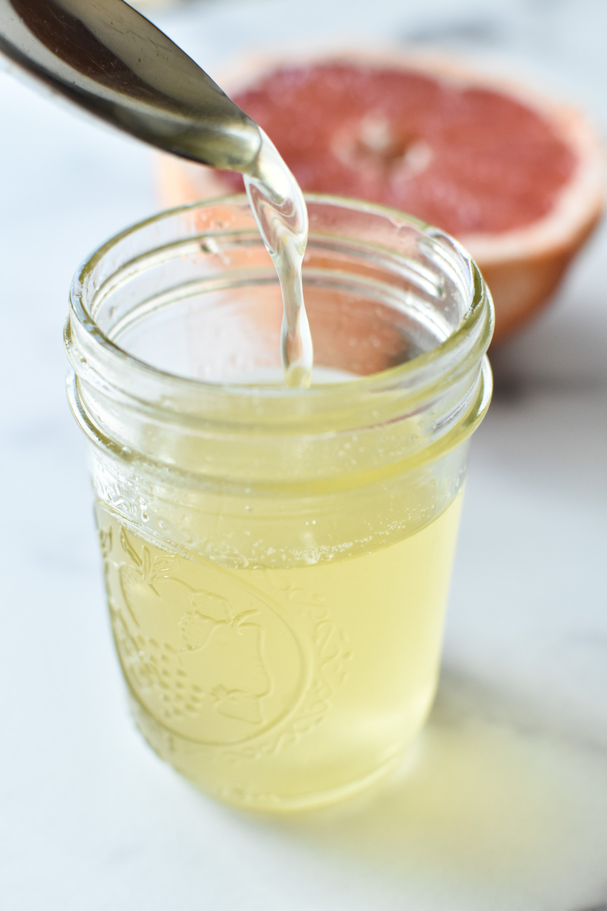 drizzle of grapefruit simple syrup into a jar