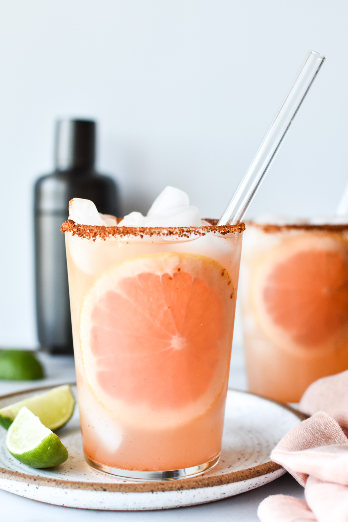 mezcal paloma in a glass with limes