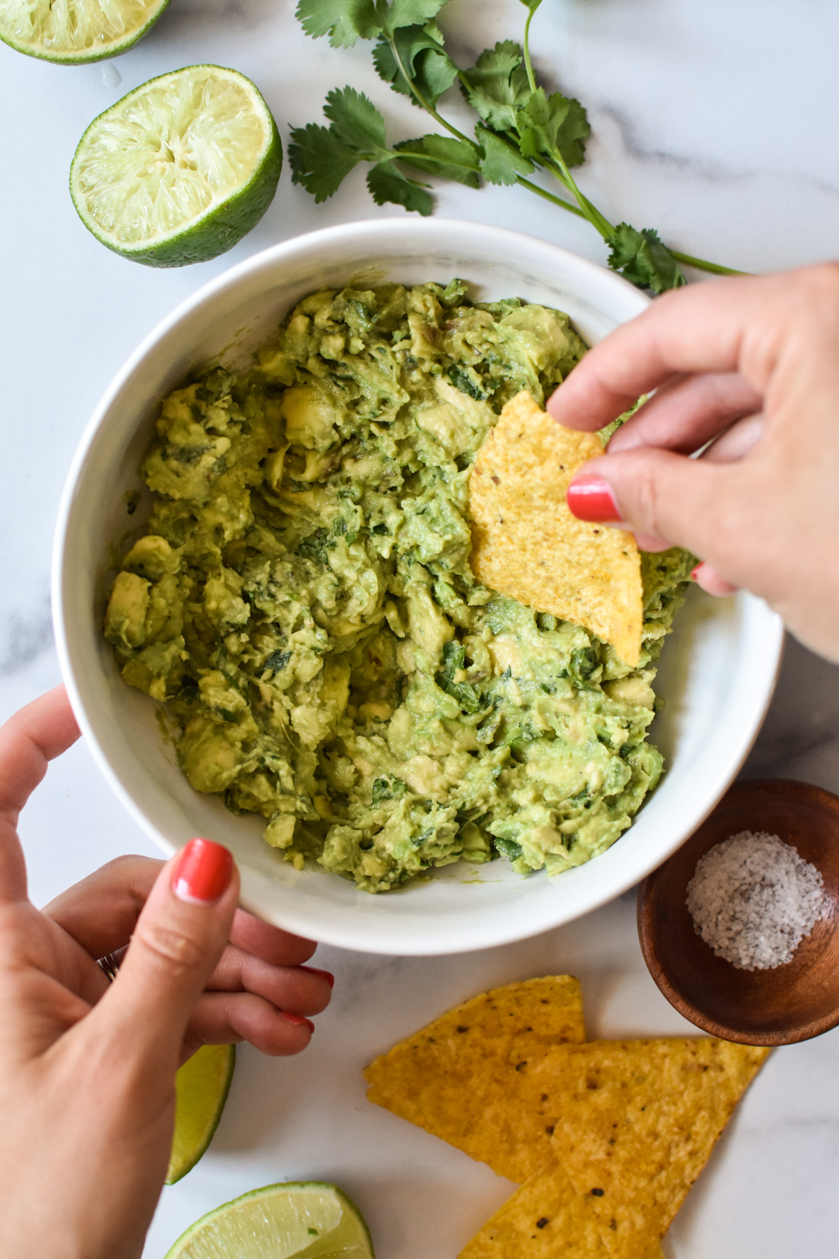 dipping a tortilla chip in 4 ingredient guacamole