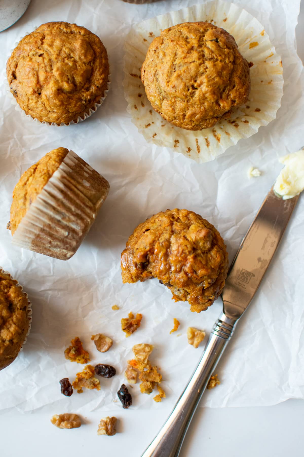 muffins next to a butter knife