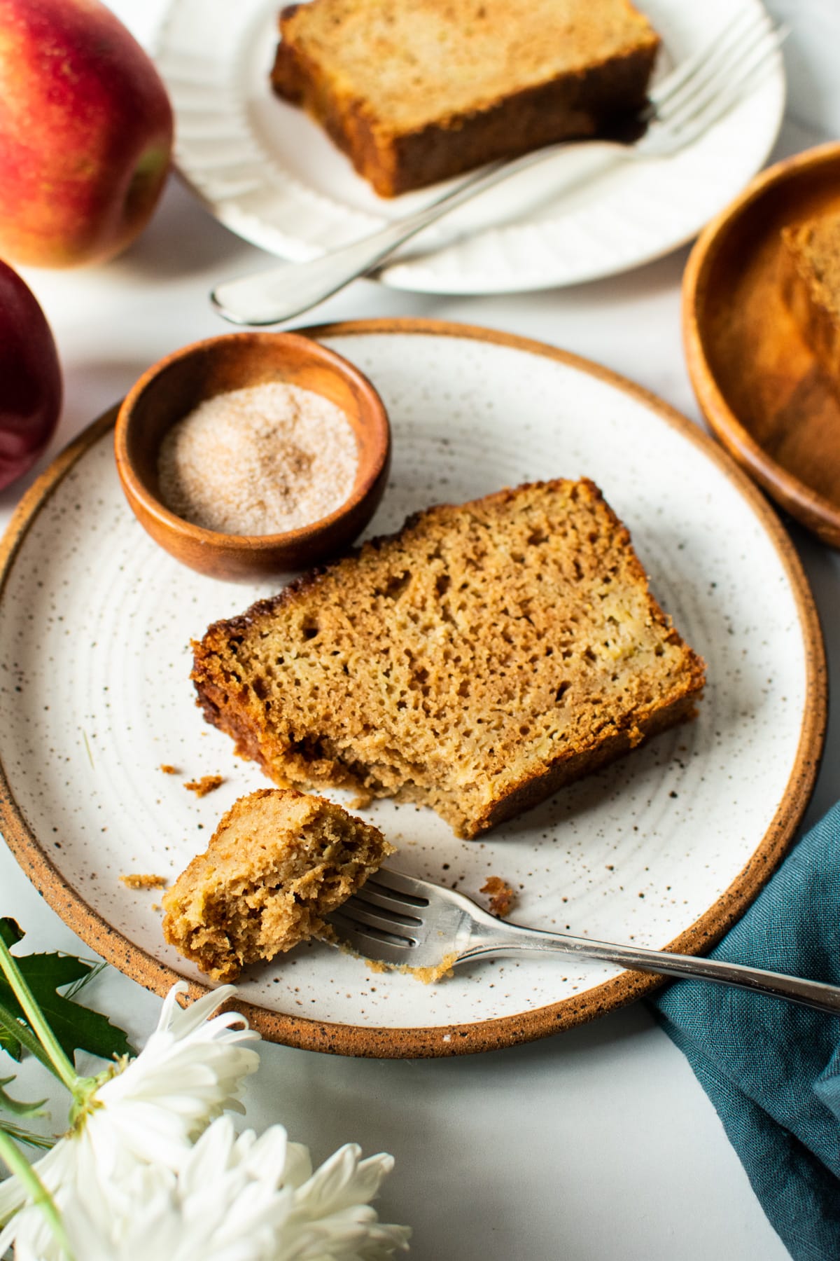 slice of apple bread on a plate with chai sugar on the side