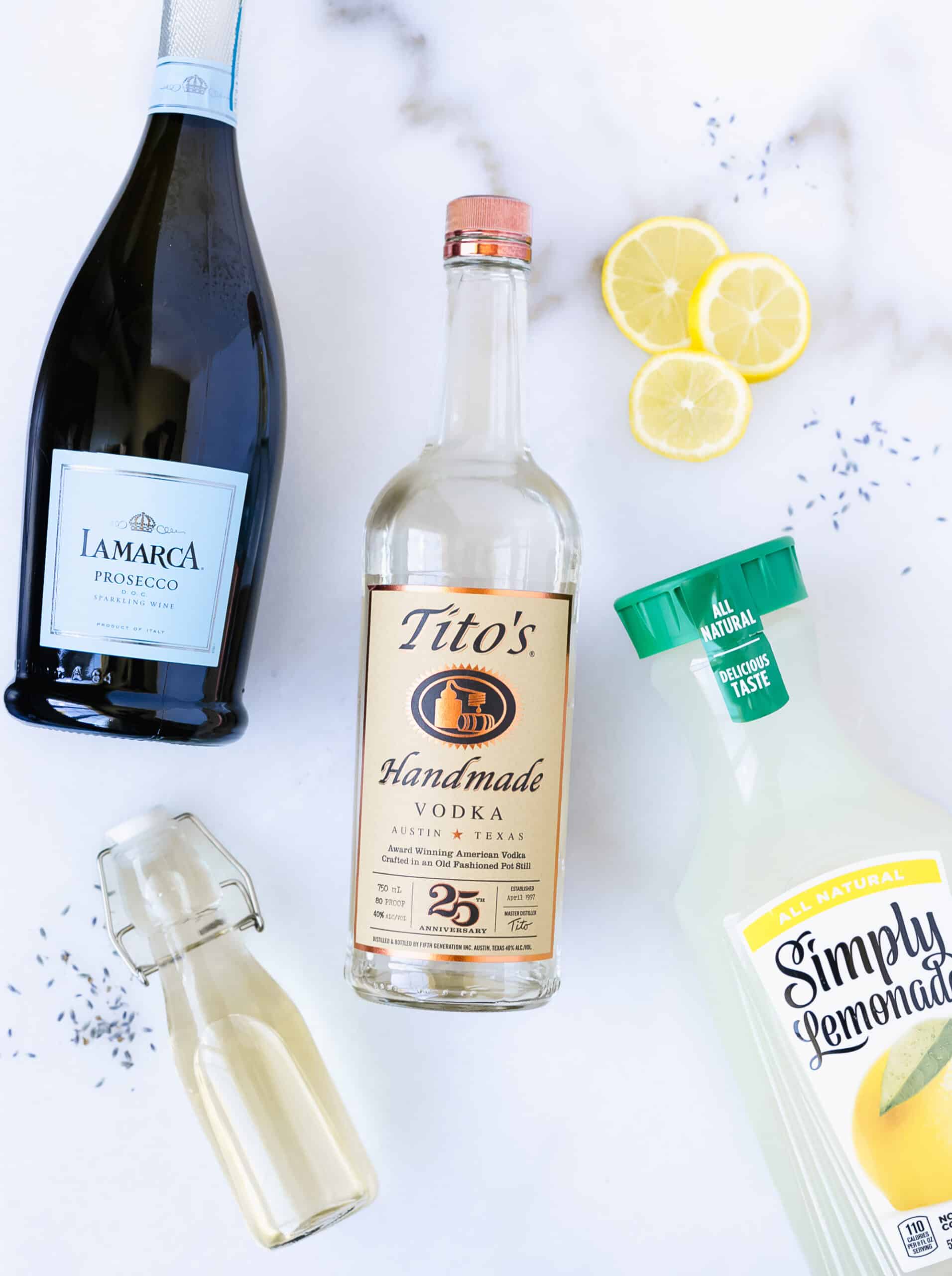 prosecco, vodka, lemon slices, bottle of lemonade, bottle of lavender simple syrup