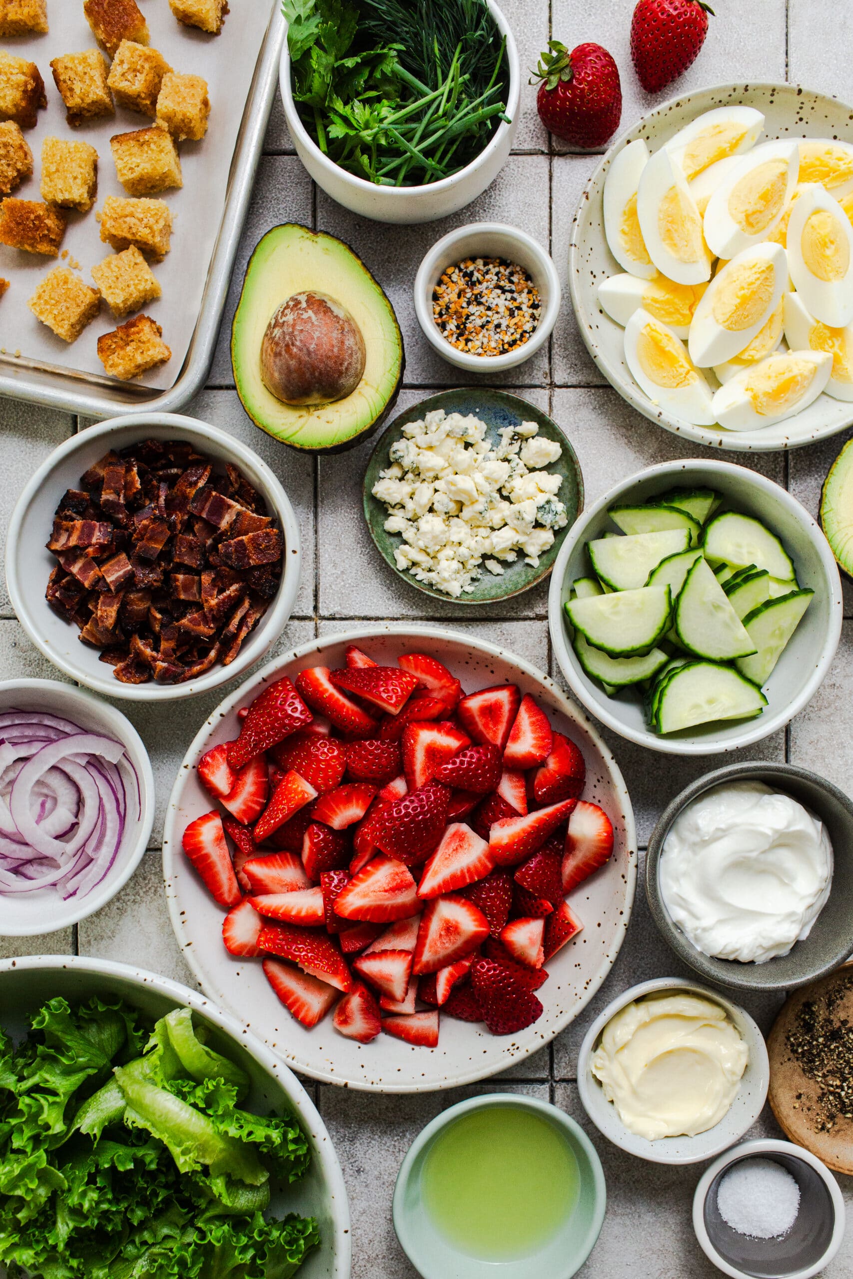 ingredients for strawberry cobb salad in individual bowls