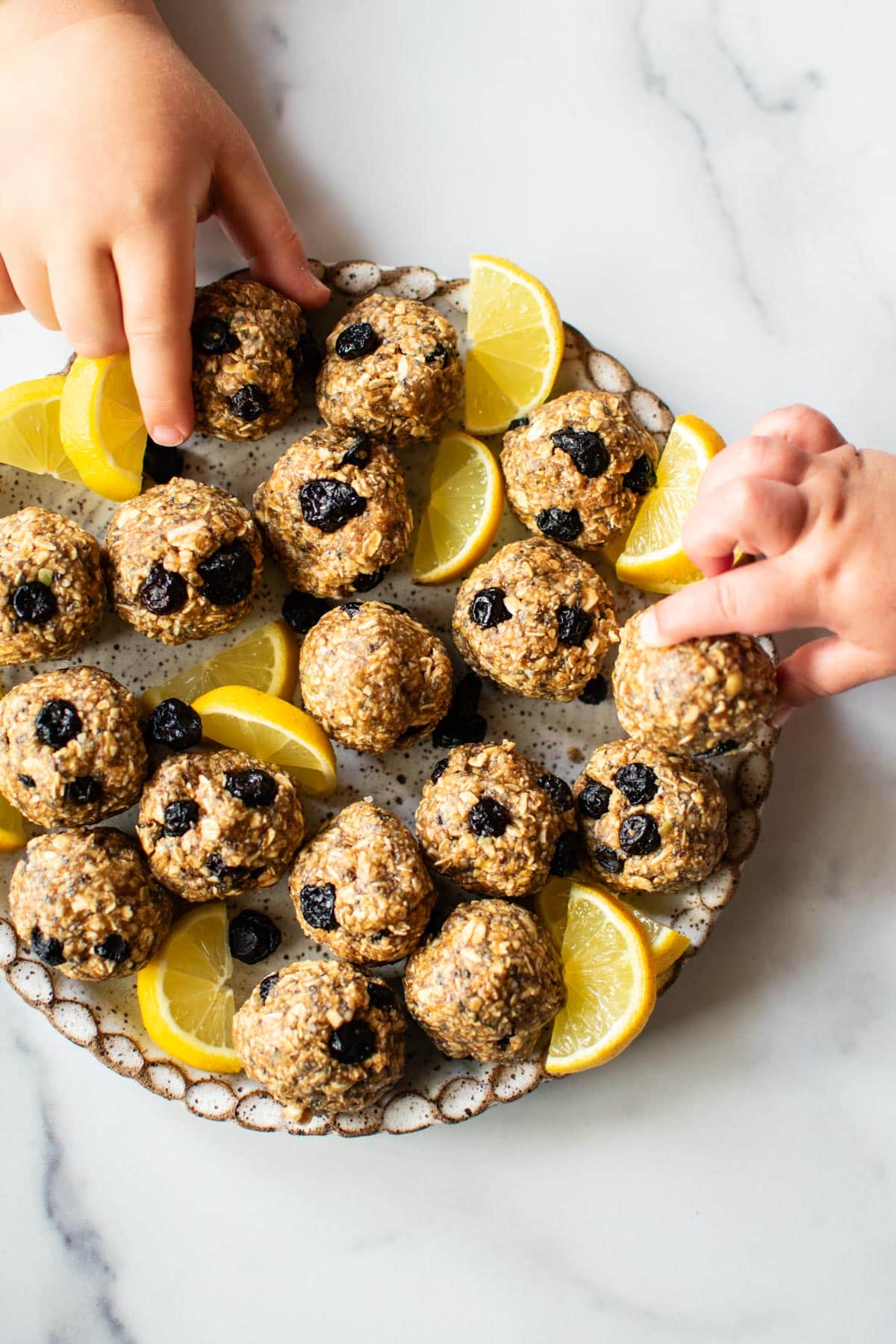 plate of oat bites with kids hands grabbing 